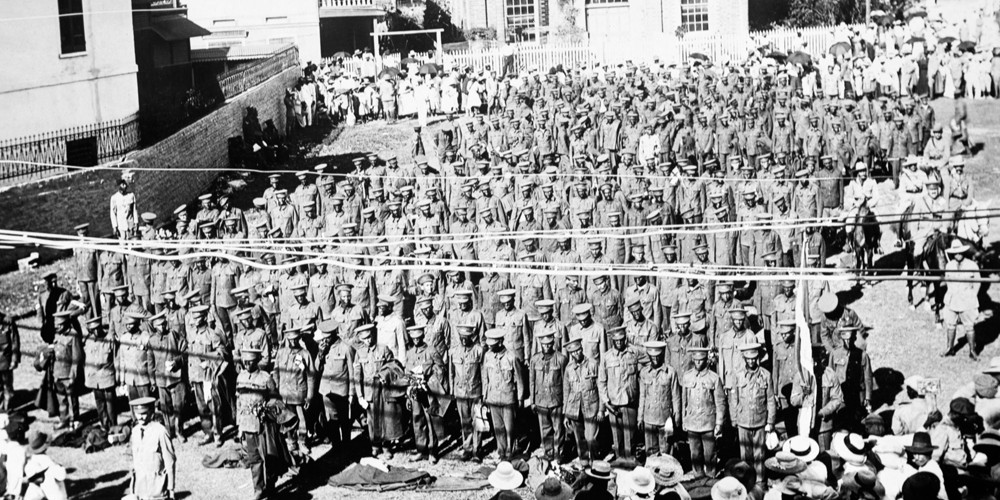 Black and white photograph showing rows of troops being inspected