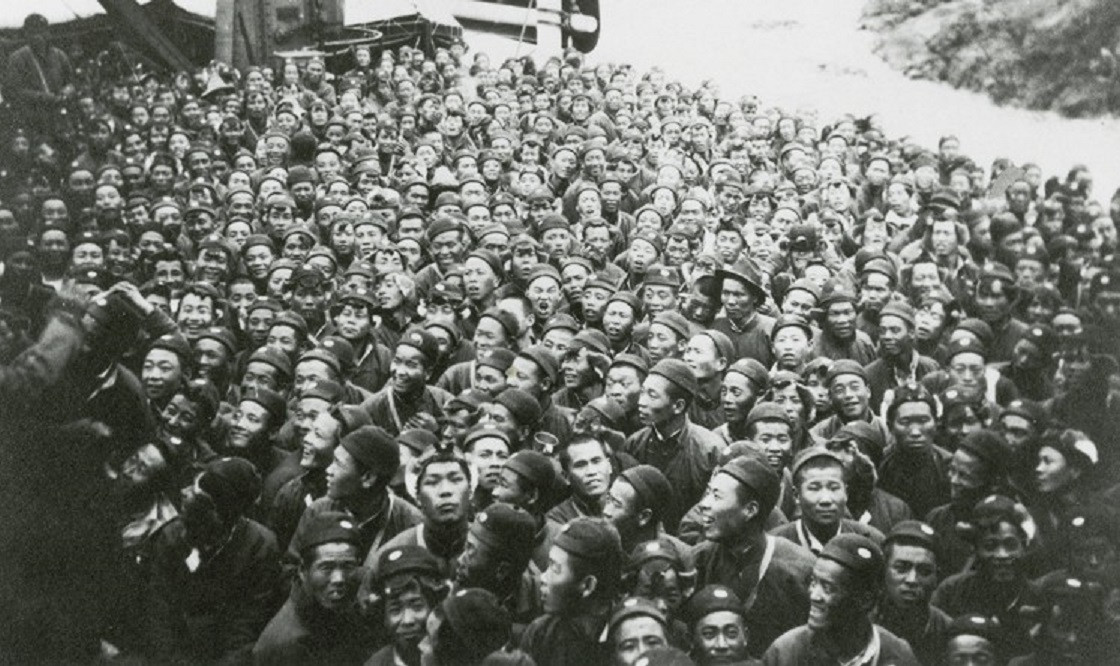 Black and white photograph showing a huge crowd of CLC workers waiting to embark for France